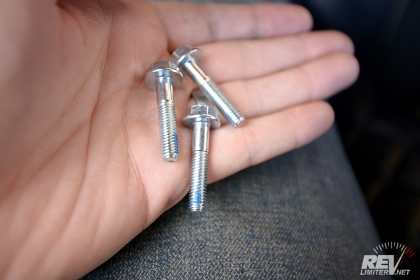 Apply a drop of the included blue thread lock onto each of the three Grade 10.9 bolts. 